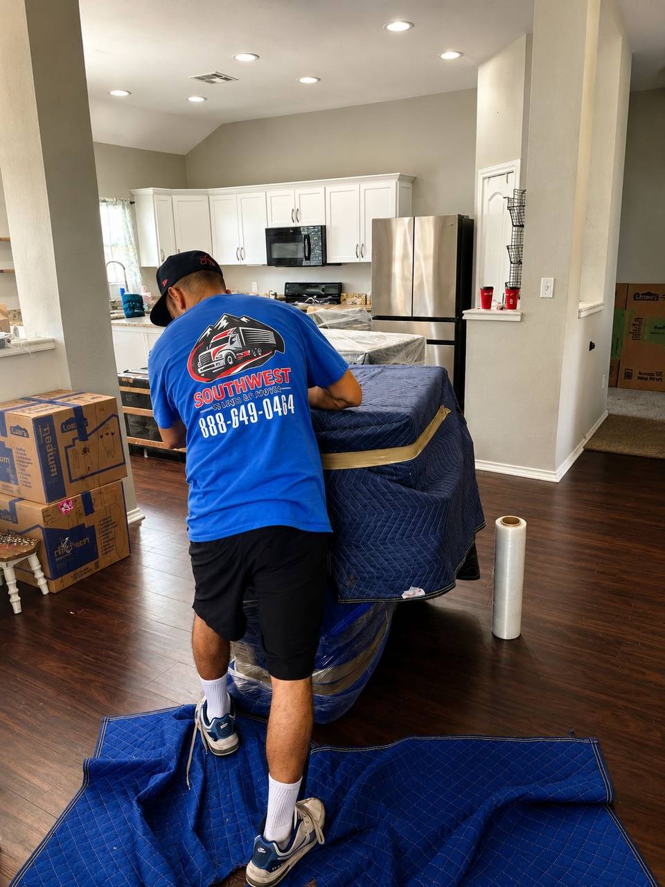 Wrapped furniture and moving boxes secured inside a moving truck
